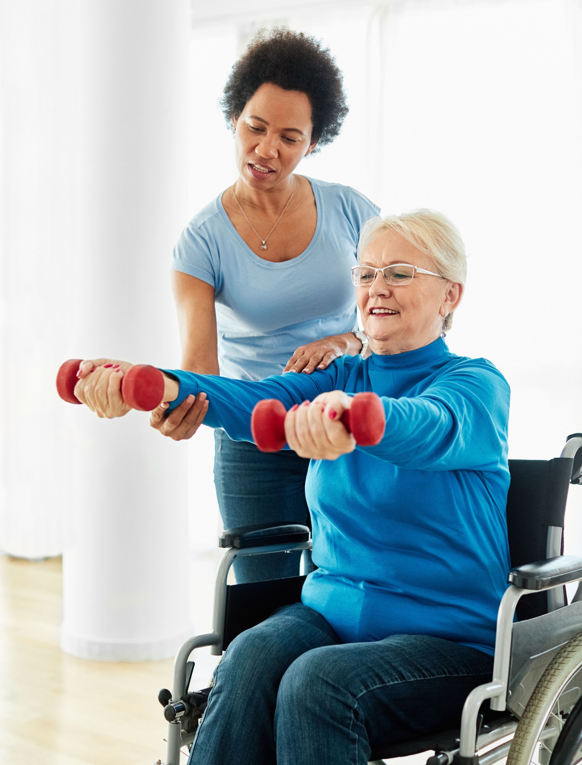 senior care exercise physical therapy exercising help assistence retirement home physiotherapy physiotherapist fitness gym strech band clinic therapist elderly woman band stretching